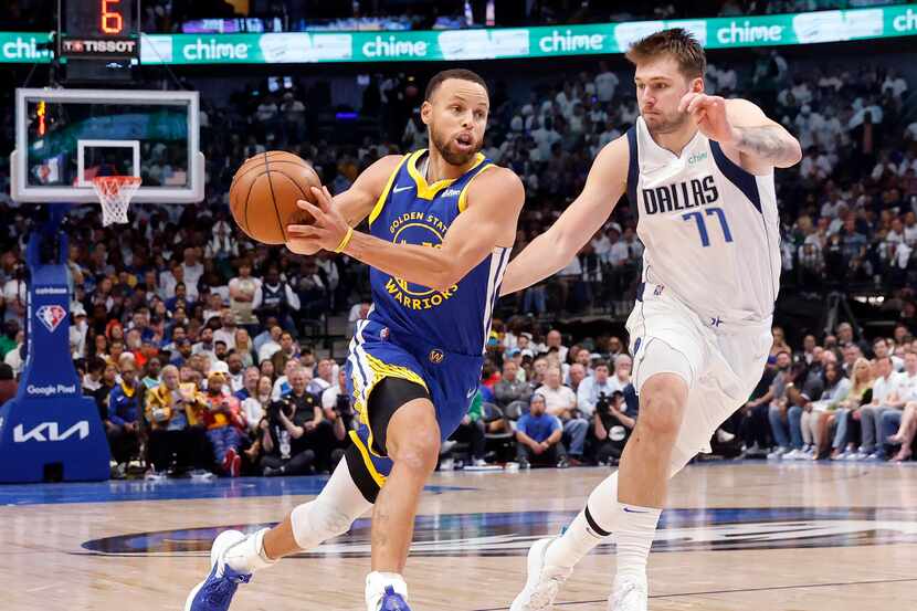 Golden State Warriors guard Stephen Curry (30) races past Dallas Mavericks guard Luka Doncic...