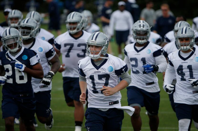 Dallas Cowboys quarterback Kellen Moore (17) runs on the field during organized team...