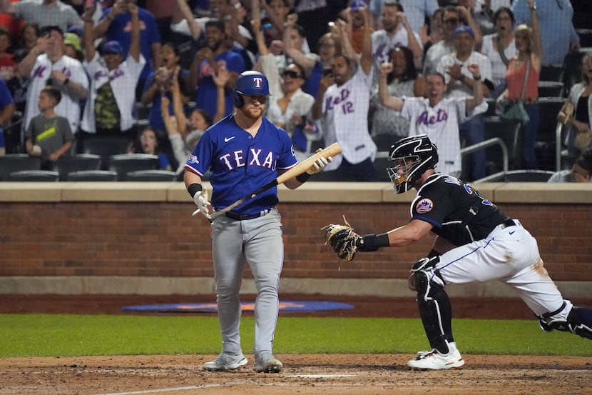 Texas Rangers' Kole Calhoun walks away after striking out to end the team's baseball game...