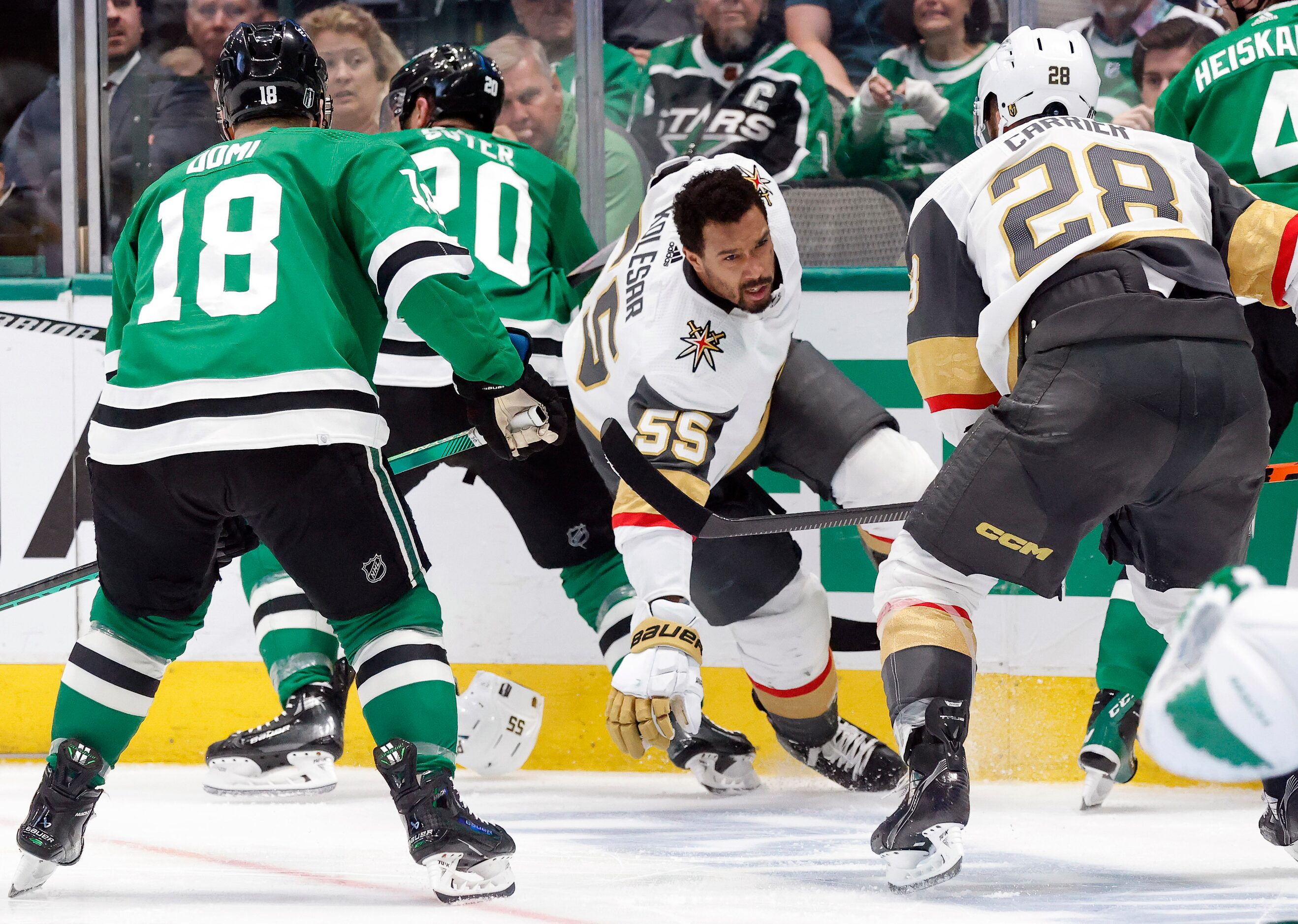 Vegas Golden Knights right wing Keegan Kolesar (55) looses his helmet after getting tied up...