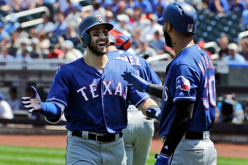 Texas Rangers' Joey Gallo, left, celebrates his home run with Nomar Mazara during the first...