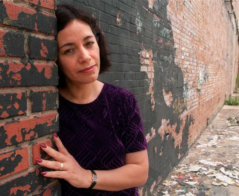 Cora Cardona, co-founder and artistic director of Teatro Dallas, leans on a wall of the...