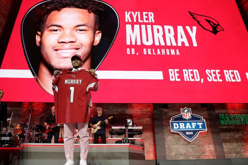 Oklahoma quarterback Kyler Murray shows off his new jersey after the Arizona Cardinals...