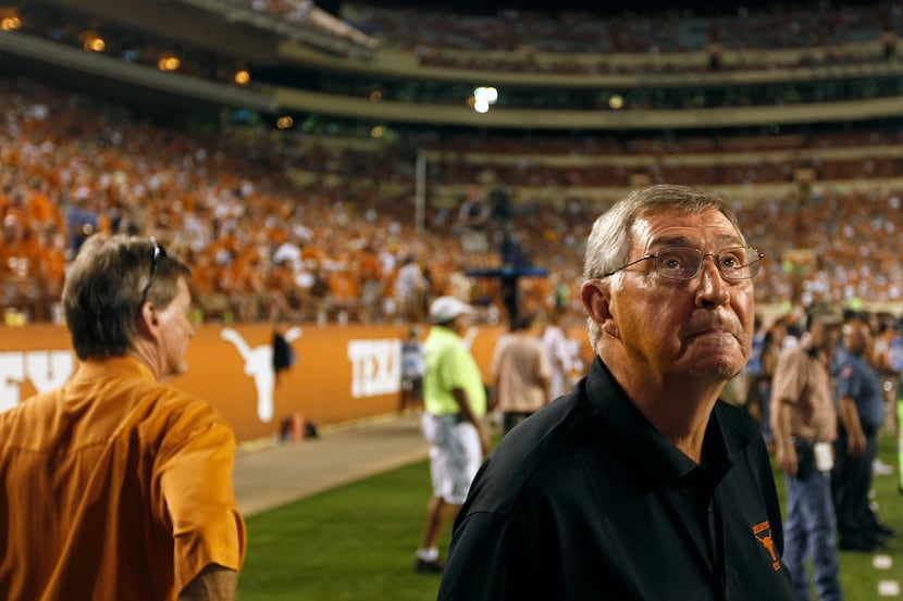 Texas men's athletic director DeLoss Dodds watches the scoreboard during the game against...