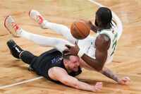 Dallas Mavericks guard Luka Doncic (77) dives for a ball against Boston Celtics guard Jaylen...