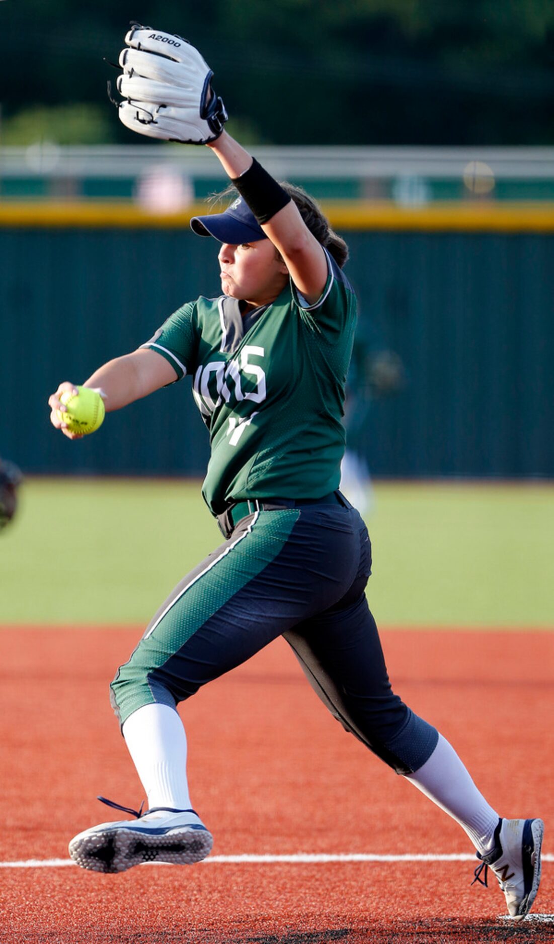 Frisco Reedy High School pitcher Micaela Wark (14) delivers a pitch in the first inning as...