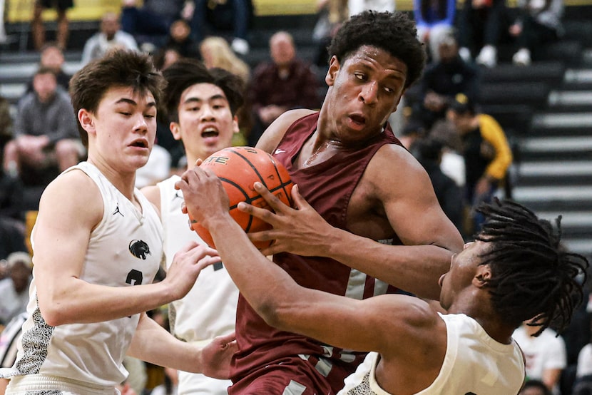 Plano Senior High School’s Justin McBride (21) knocks over Plano East Senior High’s Isaiah...