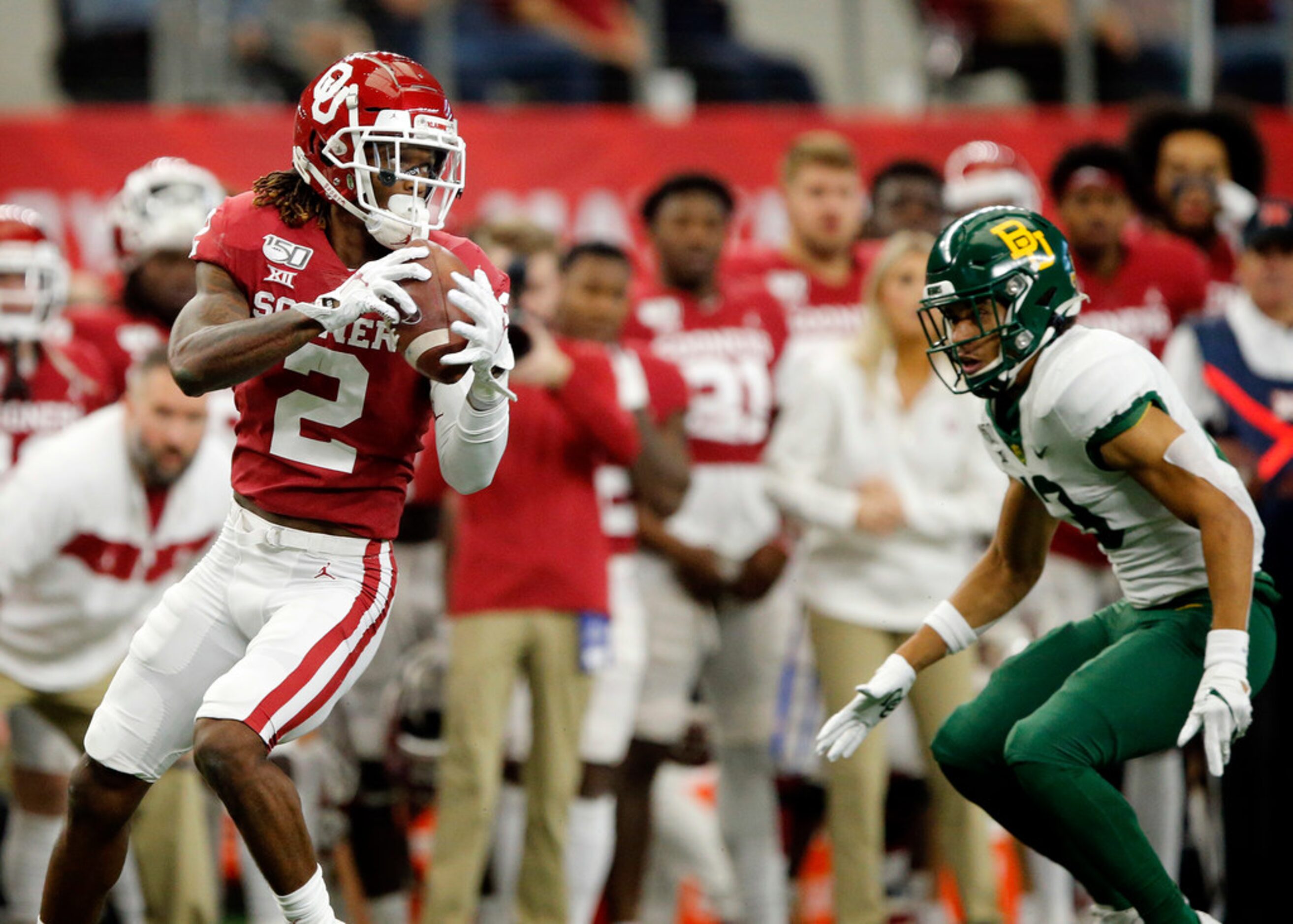 Oklahoma Sooners wide receiver CeeDee Lamb (2) pulls in a pass completion before racing down...