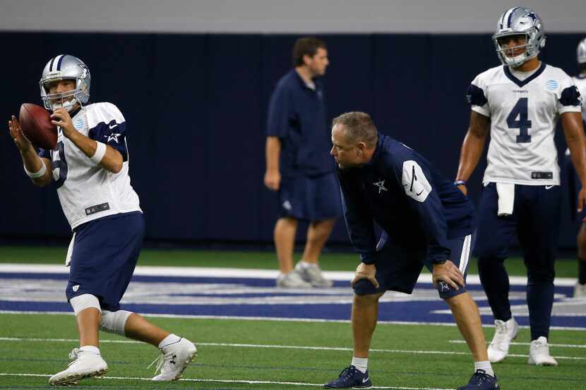 Cowboys quarterback Dak Prescott (4) watches quarterback Tony Romo (9) getting a snap during...