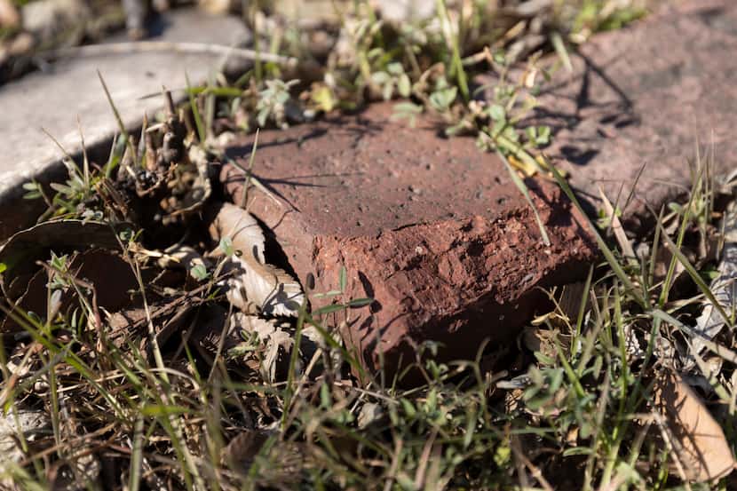Bricks from the original building lay among the grass and leaves in the lot where B.F....
