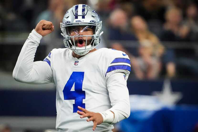 Dallas Cowboys quarterback Dak Prescott celebrates after throwing a 9-yard touchdown pass to...