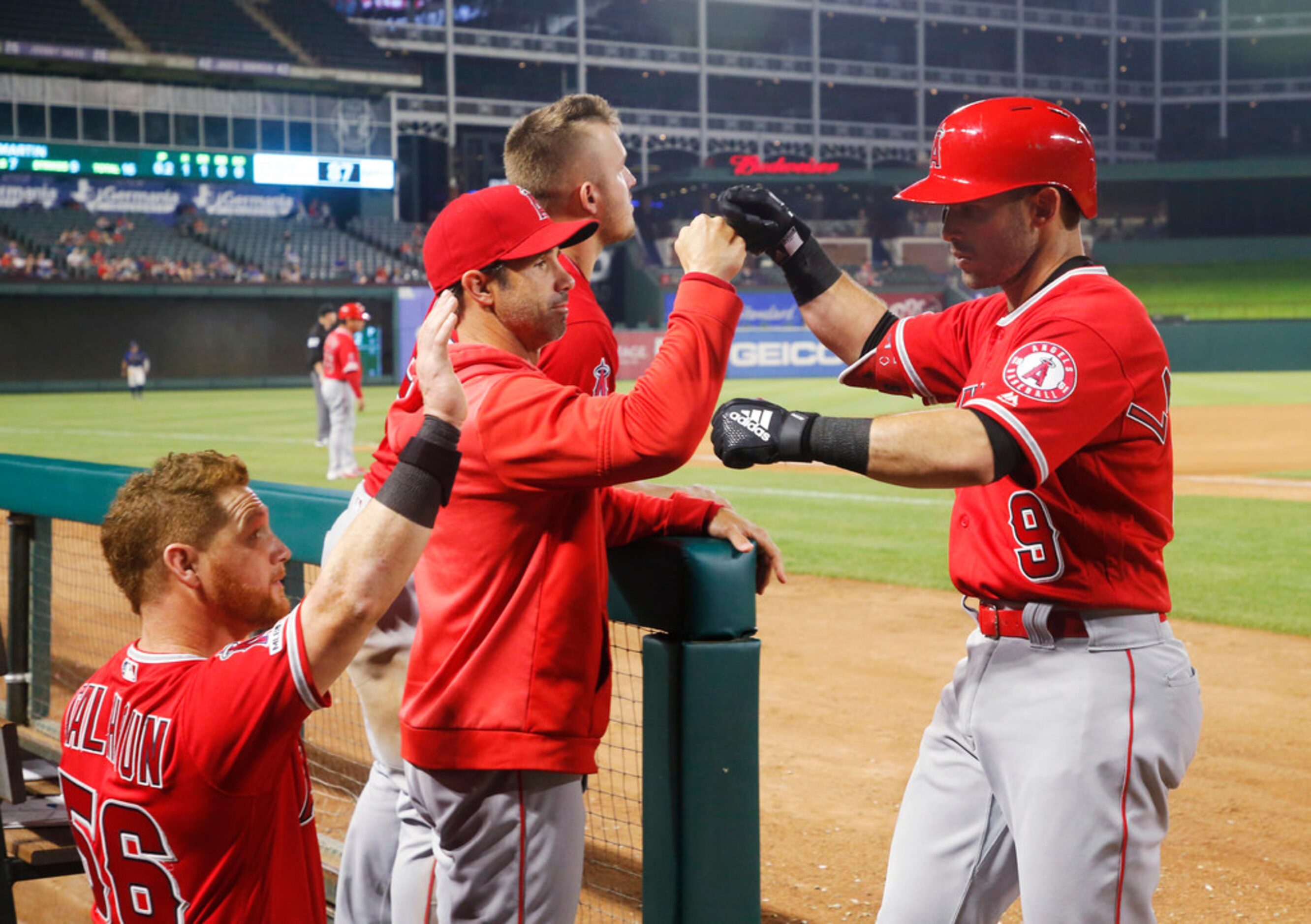 Los Angeles Angels' Kole Calhoun (56), manager Brad Ausmus, and Mike Trout congratulate...