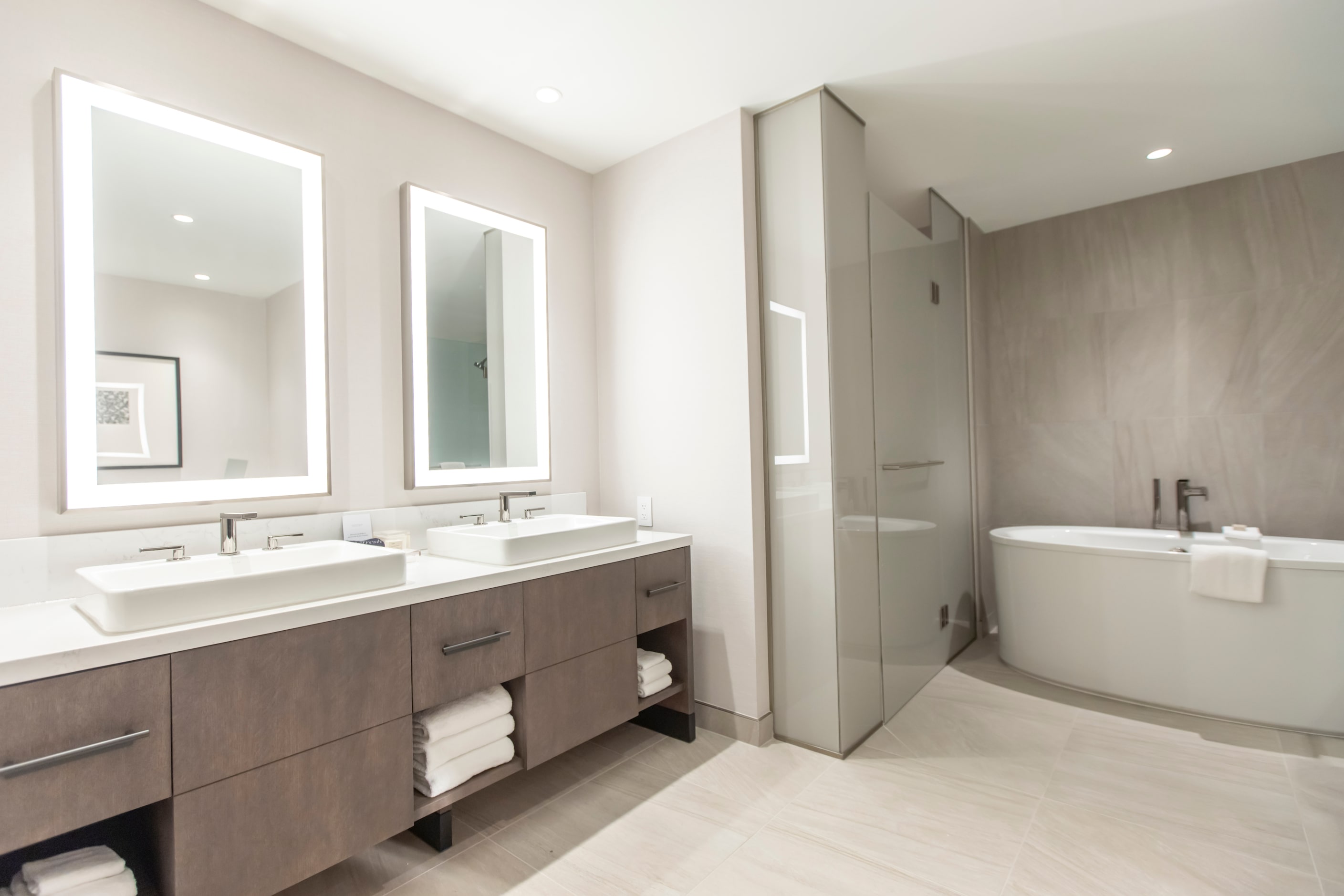 Signature Suite bathrooms have soaking tubs. All rooms include water closets and walk-in...