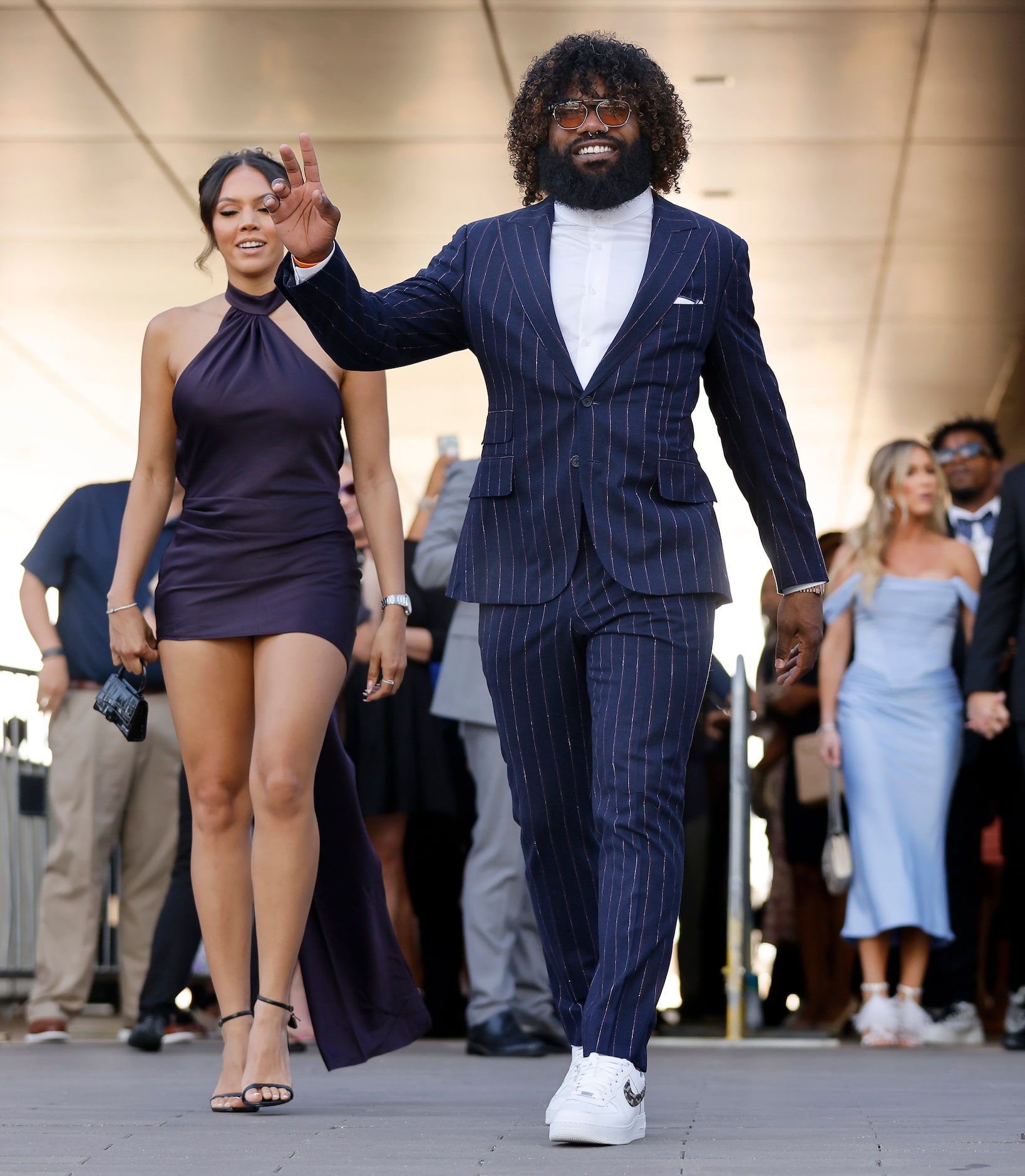 Dallas Cowboys running back Ezekiel Elliott waves to fans as he arrives to the Dallas...