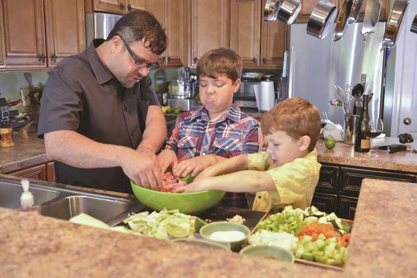 Anthony Lamas  and his sons Ethan (middle) and Ian prepare lamb meatballs.