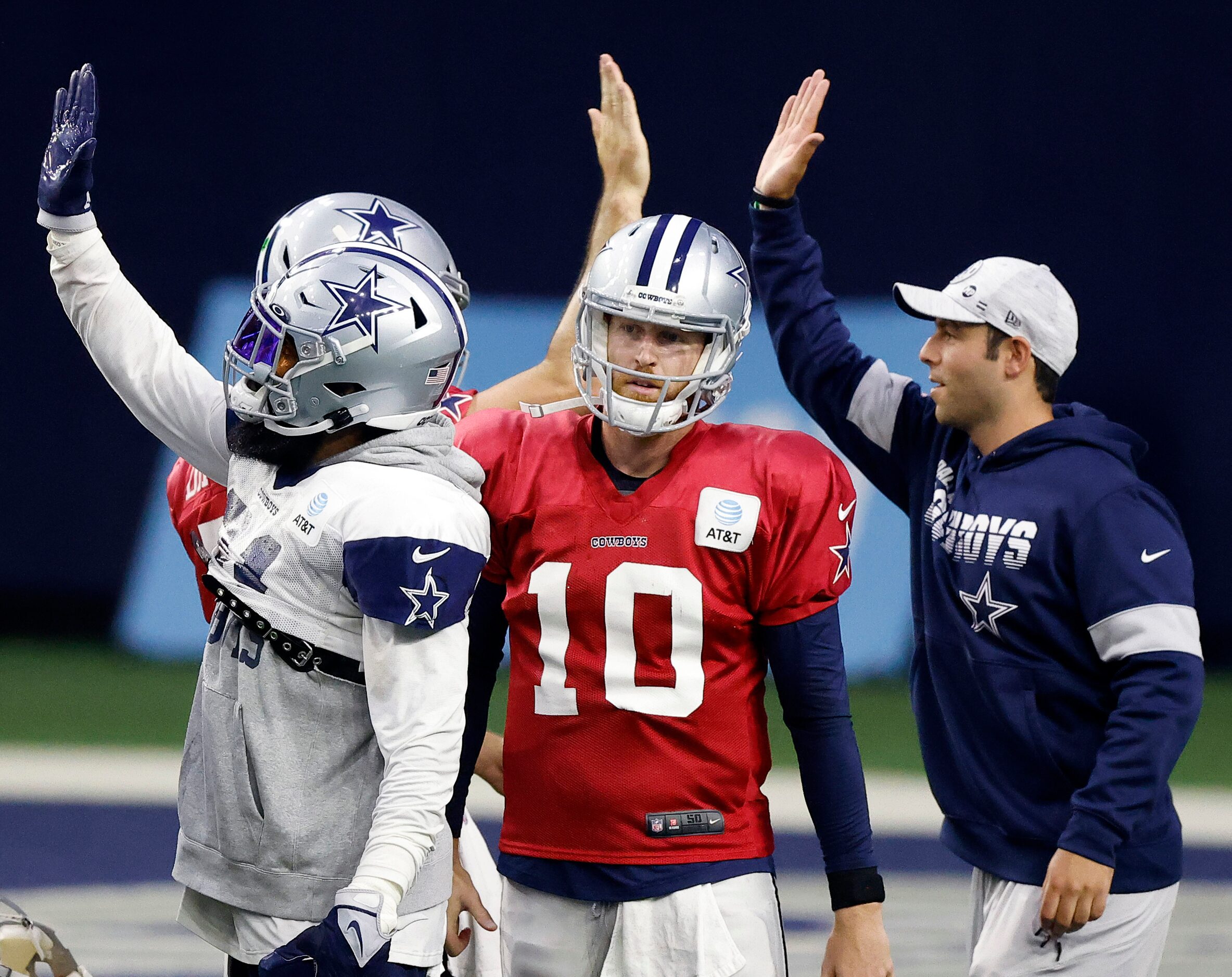 High fives all around as Dallas Cowboys quarterback Cooper Rush (10) prepares to run a play...