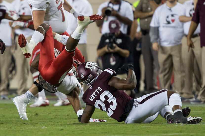 Texas A&M defensive back Armani Watts (23) upends Nicholls State wide receiver Jarrell...