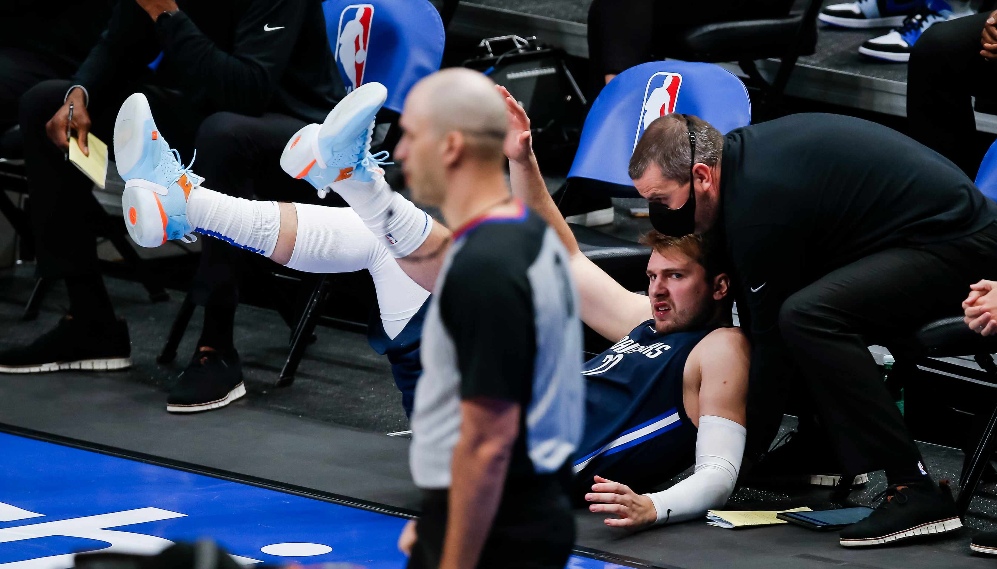 Dallas Mavericks guard Luka Doncic (77) falls out of bounds during the second half of an NBA...