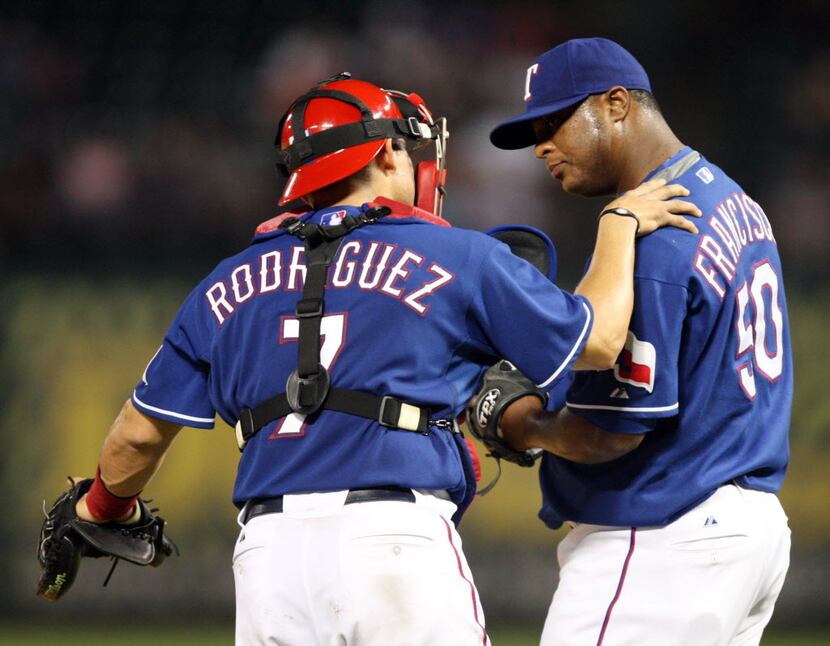 Texas Rangers' Ivan Rodriguez (7) talks with Fank Francisco (50) in a game against the...