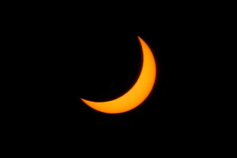 A partial solar eclipse is seen from downtown Dallas in 2019. A partial solar eclipse will...