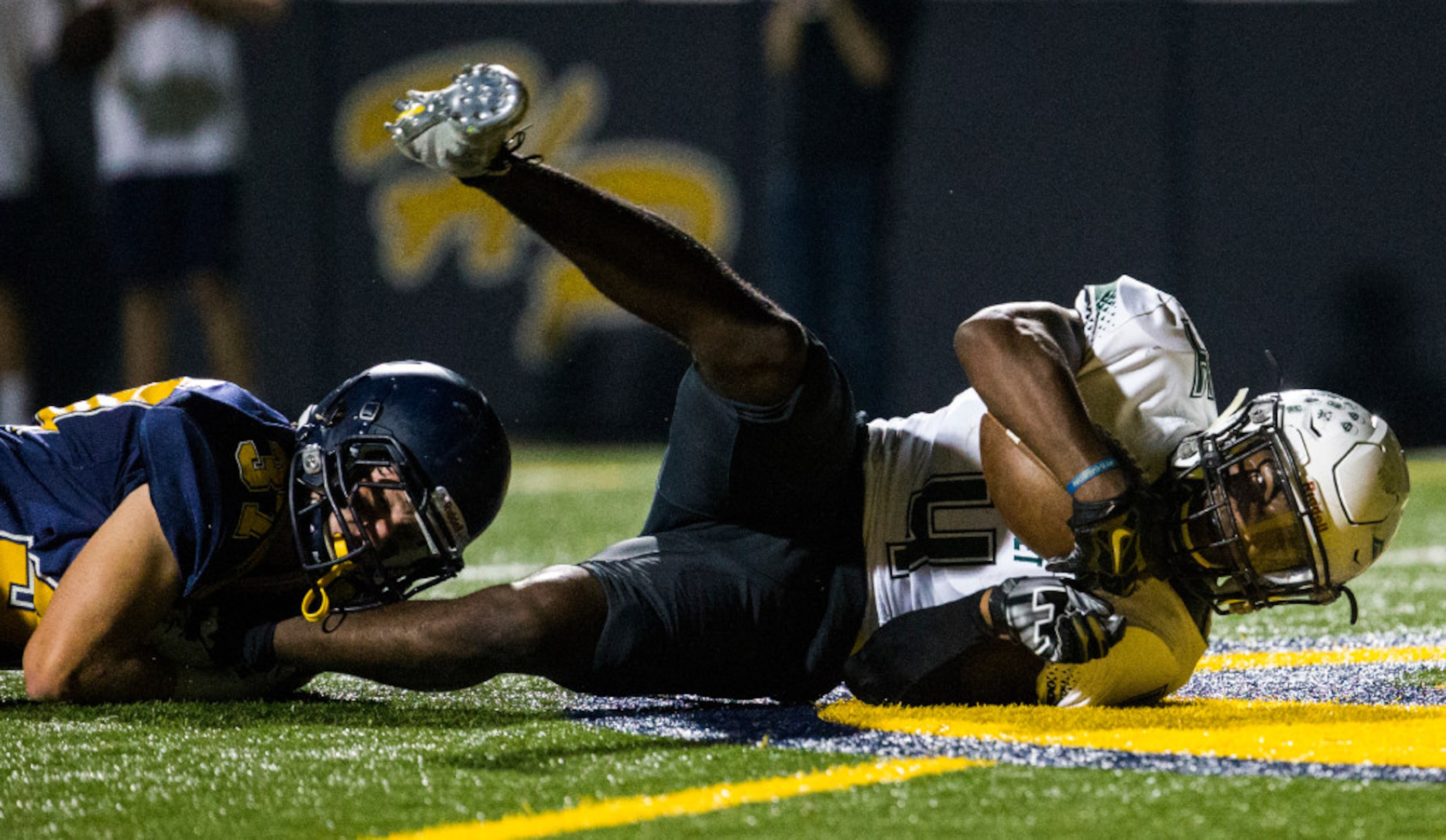 Mesquite Poteet running back Daiquon Jackson (4) falls in to the end zone for a touchdown...