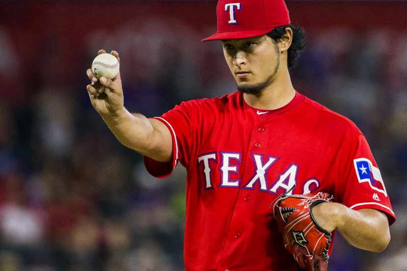 Texas Rangers starting pitcher Yu Darvish (11) lines up the ball during the sixth inning of...