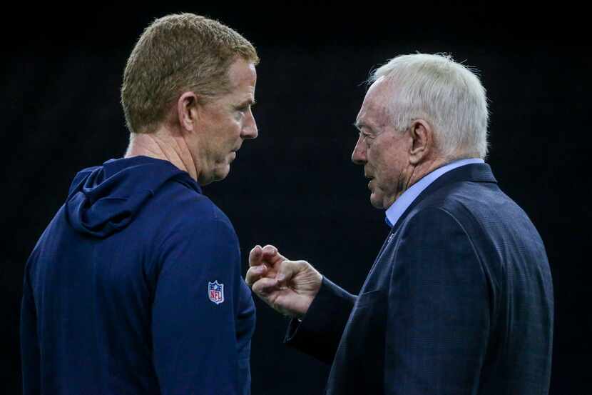 Dallas Cowboys head coach Jason Garrett, left, chats with owner Jerry Jones during the...