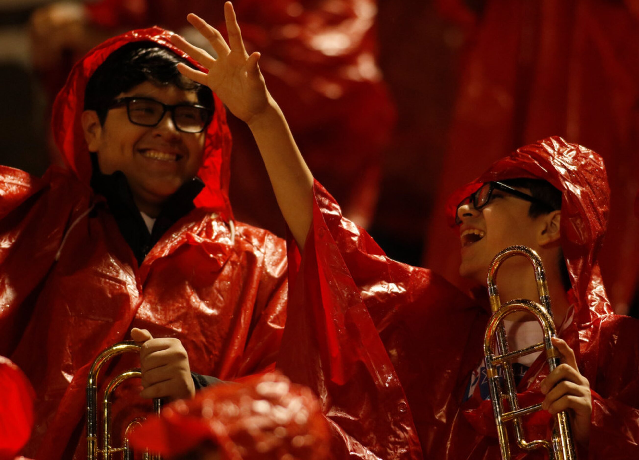 Members of the Duncanville band revel in the moment as light rain fell during the opening...