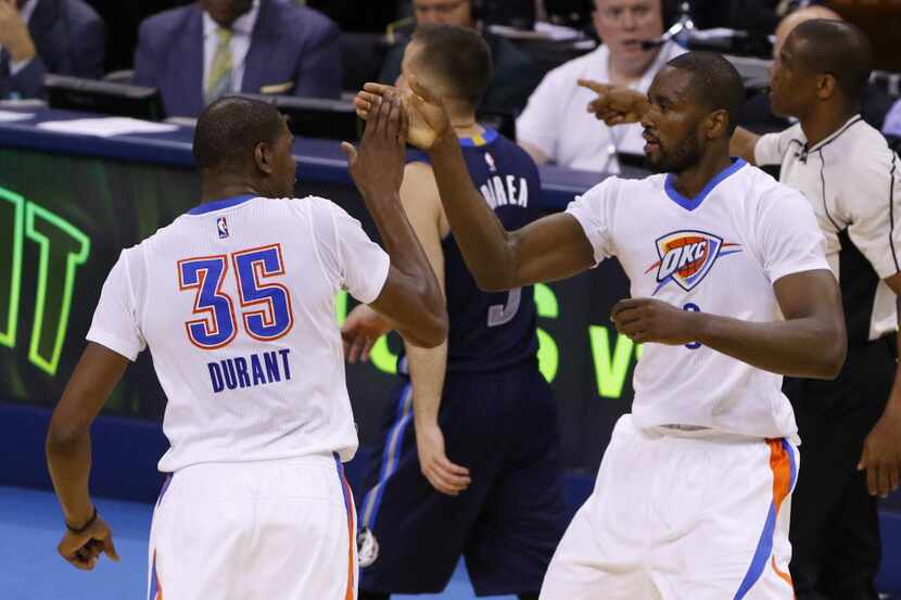 Oklahoma City Thunder forwards Kevin Durant (35) and Serge Ibaka (9) high-five during the...