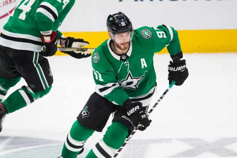 Dallas Stars center Tyler Seguin (91) and left wing Jamie Benn (14) make their way down the...