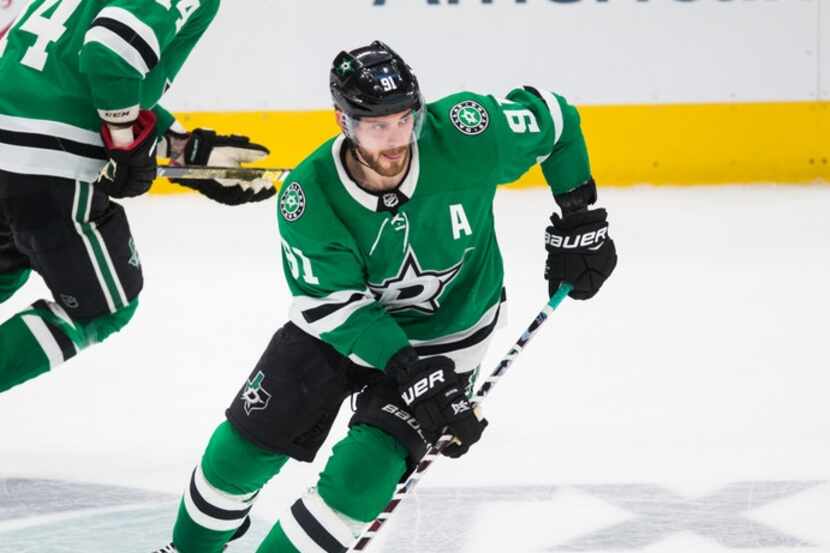 Dallas Stars center Tyler Seguin (91) and left wing Jamie Benn (14) make their way down the...