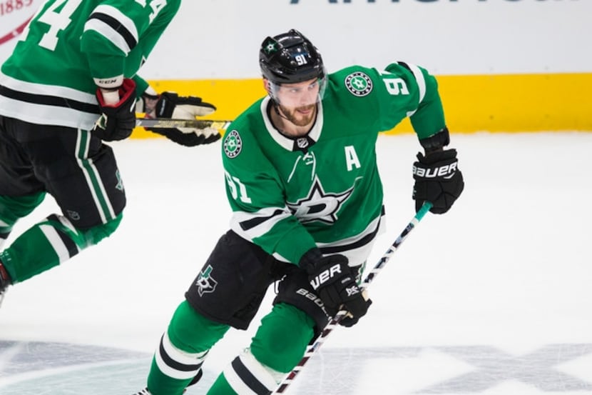 Dallas Stars center Tyler Seguin (91) and left wing Jamie Benn (14) make their way down the...