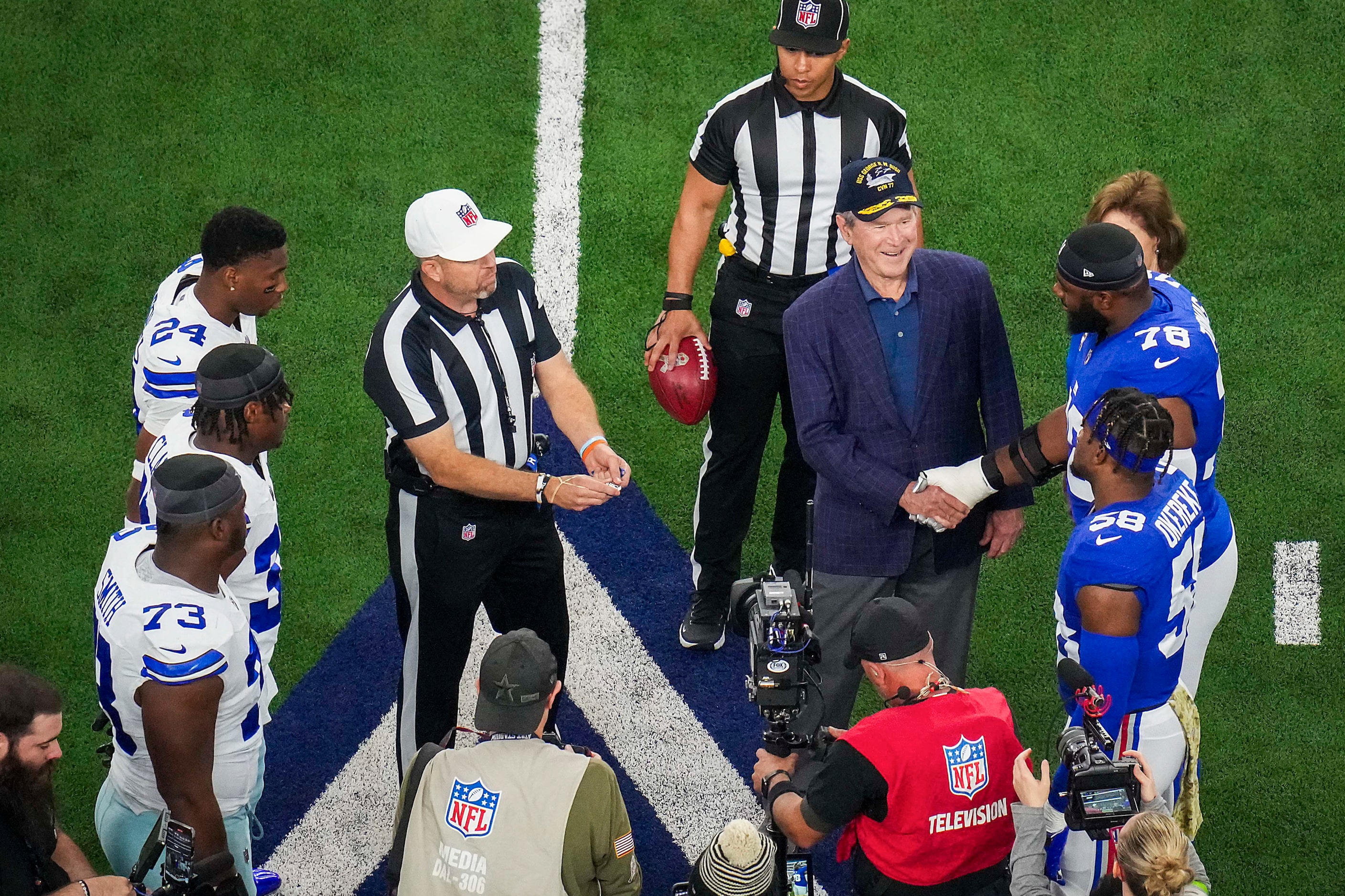 Former President George W. Bush shakes hands with New York Giants offensive tackle Andrew...