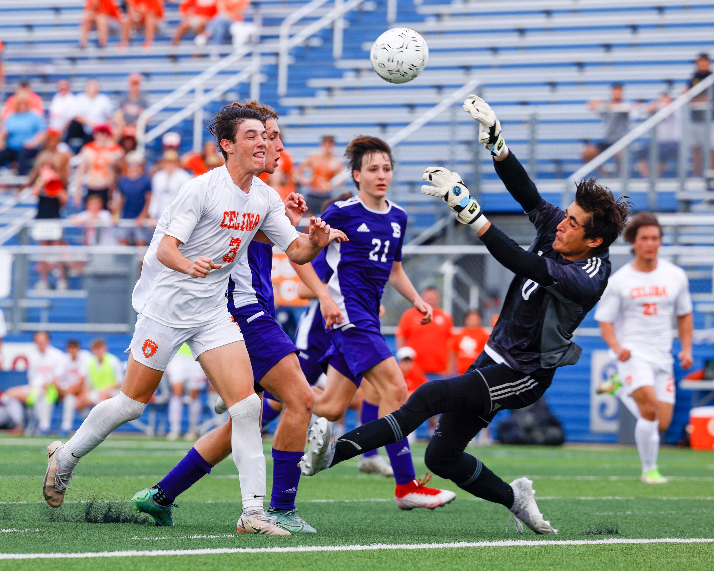 Boerne goalkeeper Noah LeMaster (0) knocks the ball away from a rushing Celina forward...