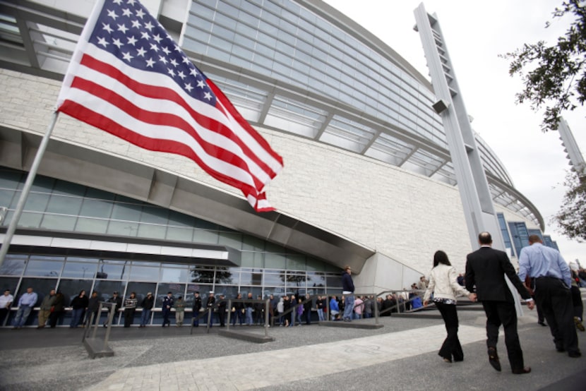 People wait in line to enter the stadium before a memorial service for Chris Kyle at Cowboys...