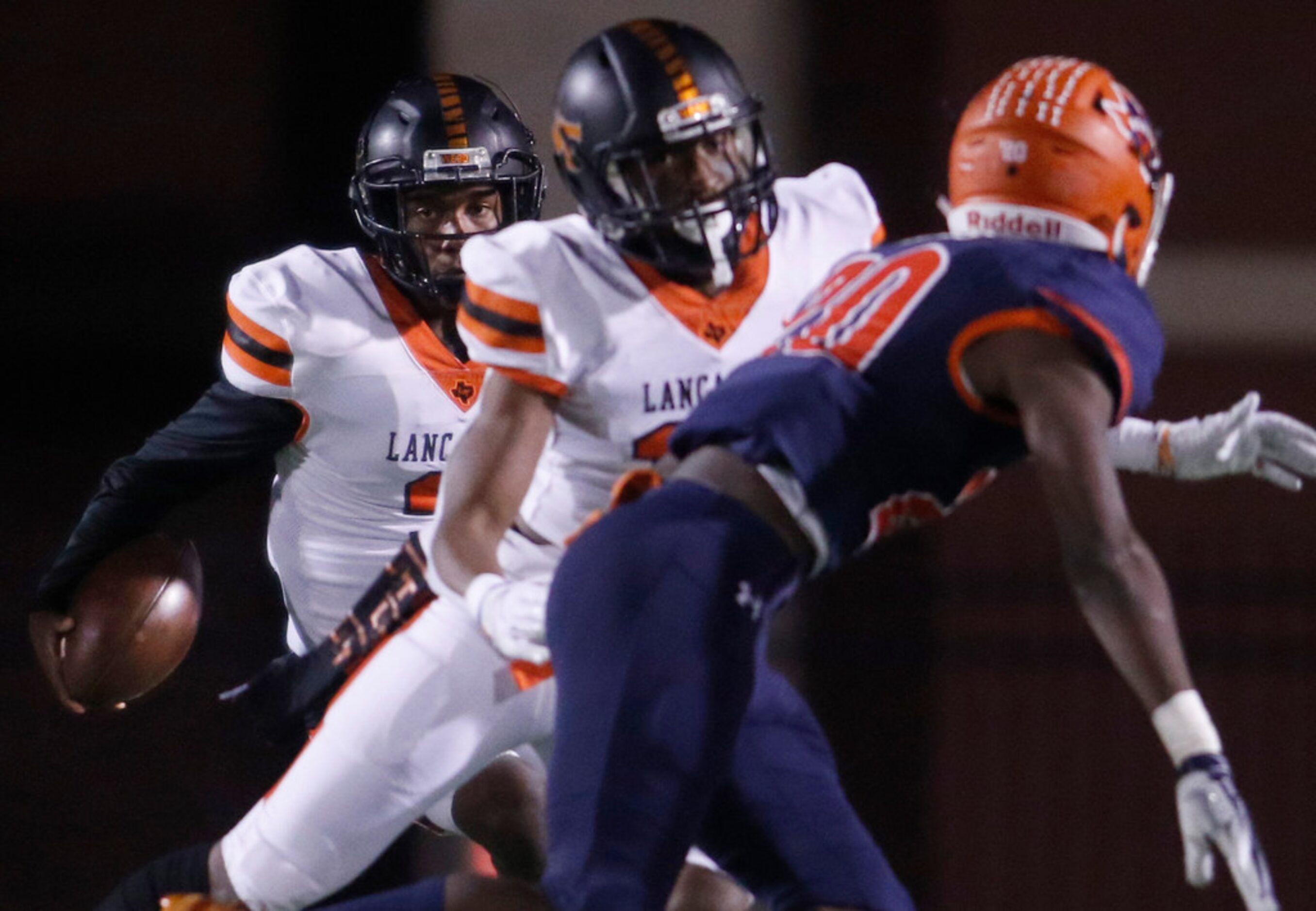 Lancaster quarterback Glenn Rice Jr. (3) follows a block from receiver LD Fair (10) against...