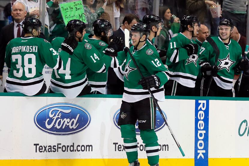 Dallas Stars' Radek Faksa of the Czech Republic is congratulated by the bench after scoring...