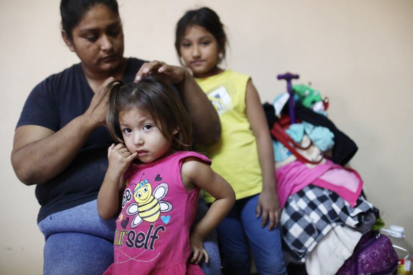 A migrant mother, who is waiting to seek asylum for herself and her two daughters in the...