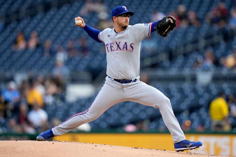 Texas Rangers relief pitcher Dane Dunning delivers during the first inning of a baseball...