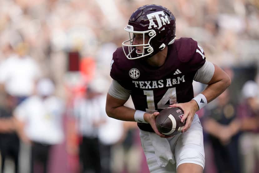 Texas A&M quarterback Max Johnson (14) looks to hand the ball off during the fourth quarter...