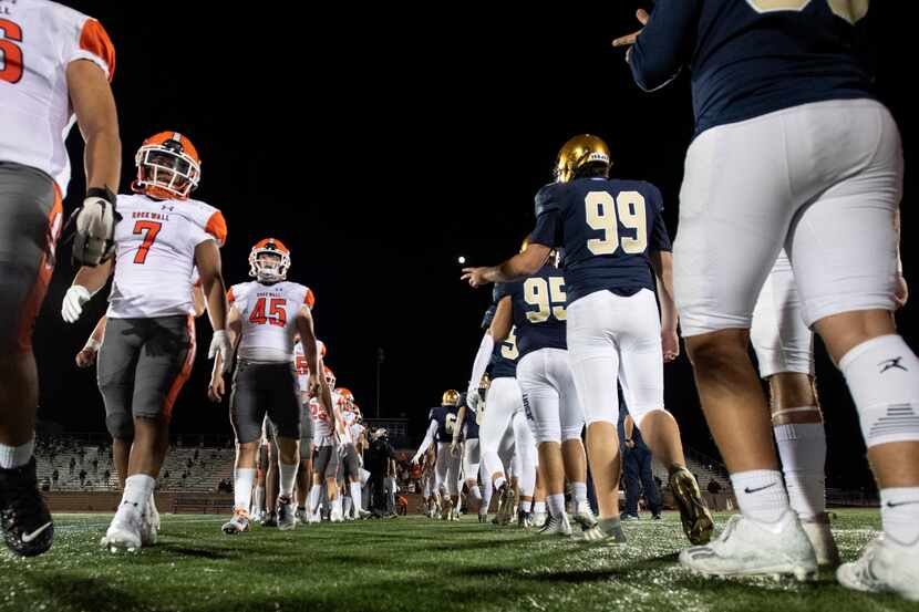 Rockwall and Jesuit players stay five yards apart instead of shaking hands, due to...