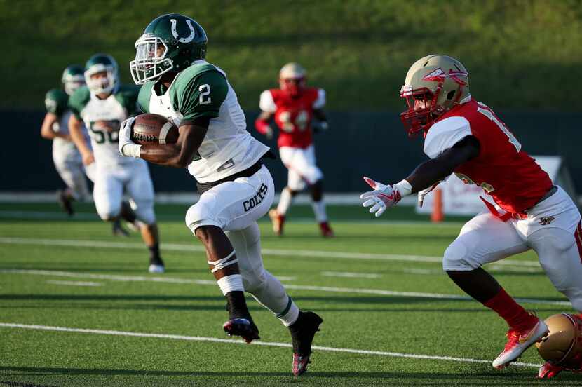 FILE - Arlington running back Kenland McCray (2) runs by South Grand Prairie defender Elisha...