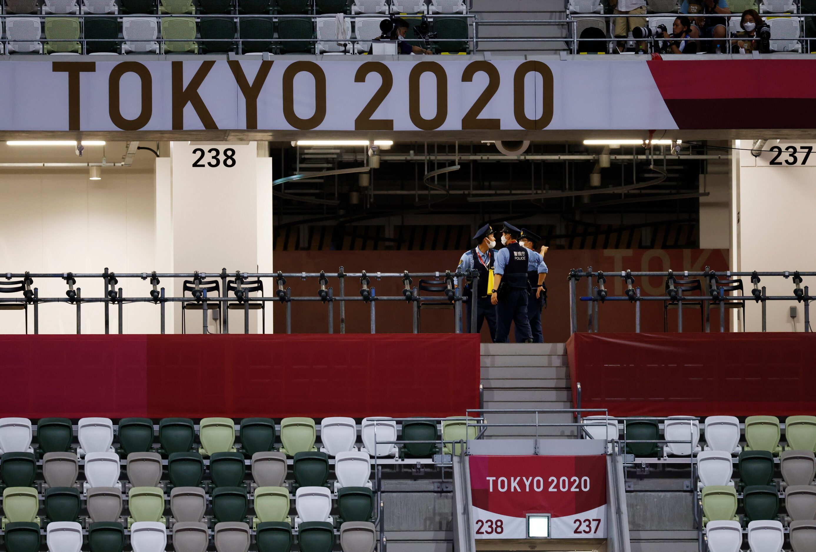 Police keep watch prior to the start of the opening ceremony for the postponed 2020 Tokyo...