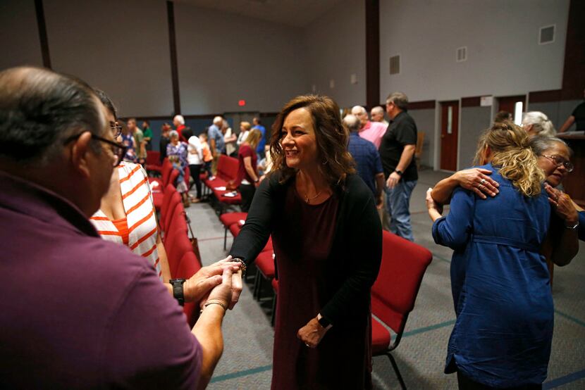 Amy Hardesty greets Marin Cebalo of Norman during a greeting period at Norman Community...