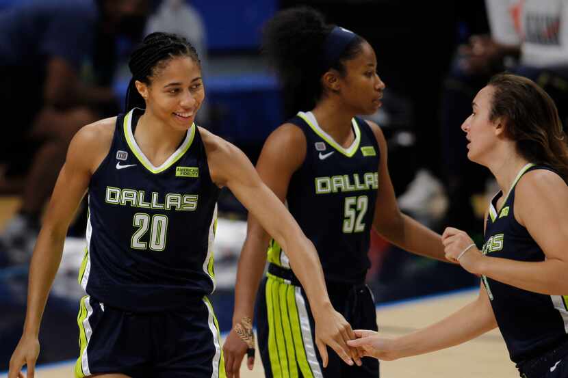 Dallas Wings forward Isabelle Harrison (20) acknowledges an assist from Wings guard Marina...