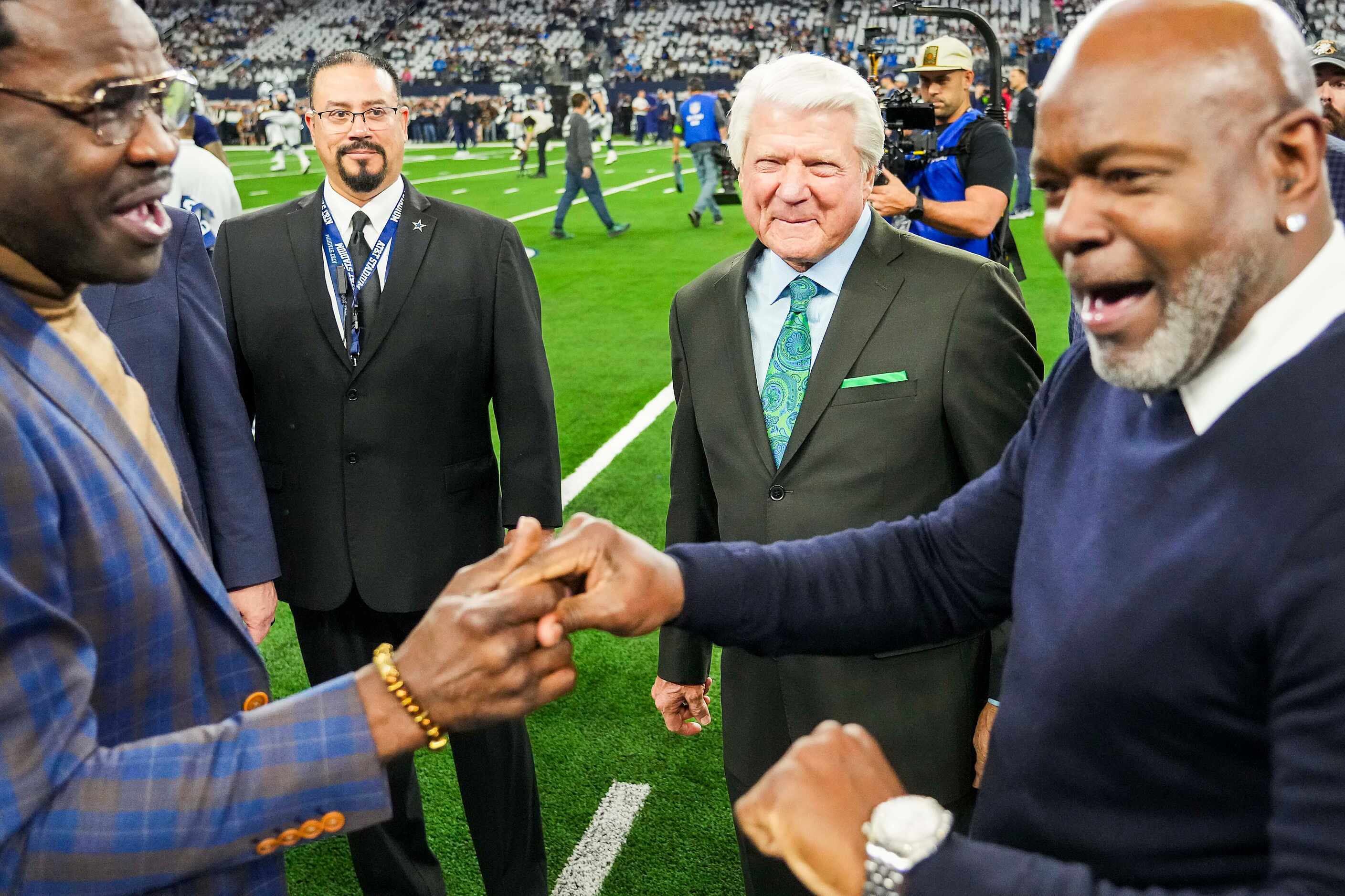 Former Dallas Cowboys coach Jimmy Johnson laughs with former players Michael Irvin (left)...