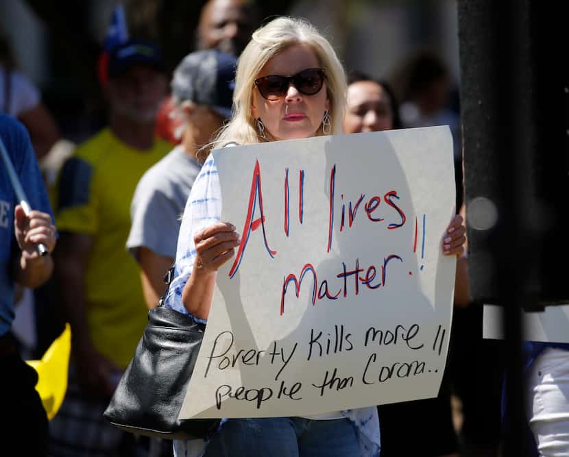 Numerous people carried signs with message similar to the one brought by this woman to the...