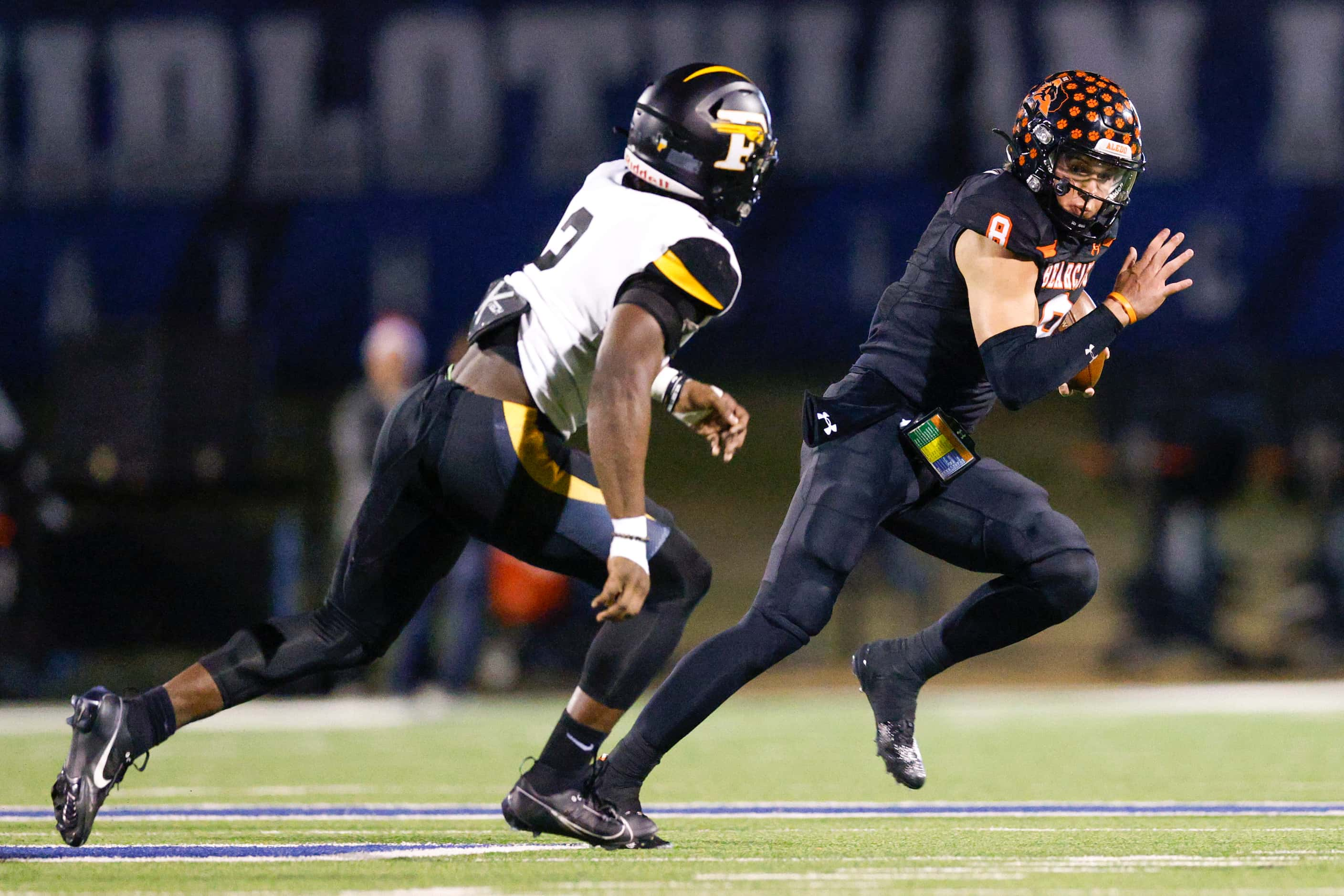 Aledo quarterback Hauss Hejny (8) runs the ball past Forney linebacker Kelvion Riggins (2)...