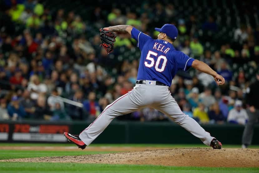 Texas Rangers pitcher Keone Kela throws against the Seattle Mariners during a baseball game,...