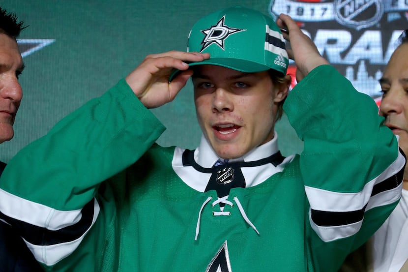 CHICAGO, IL - JUNE 23:  Miro Heiskanen puts on a Dallas Stars hat after being selected third...